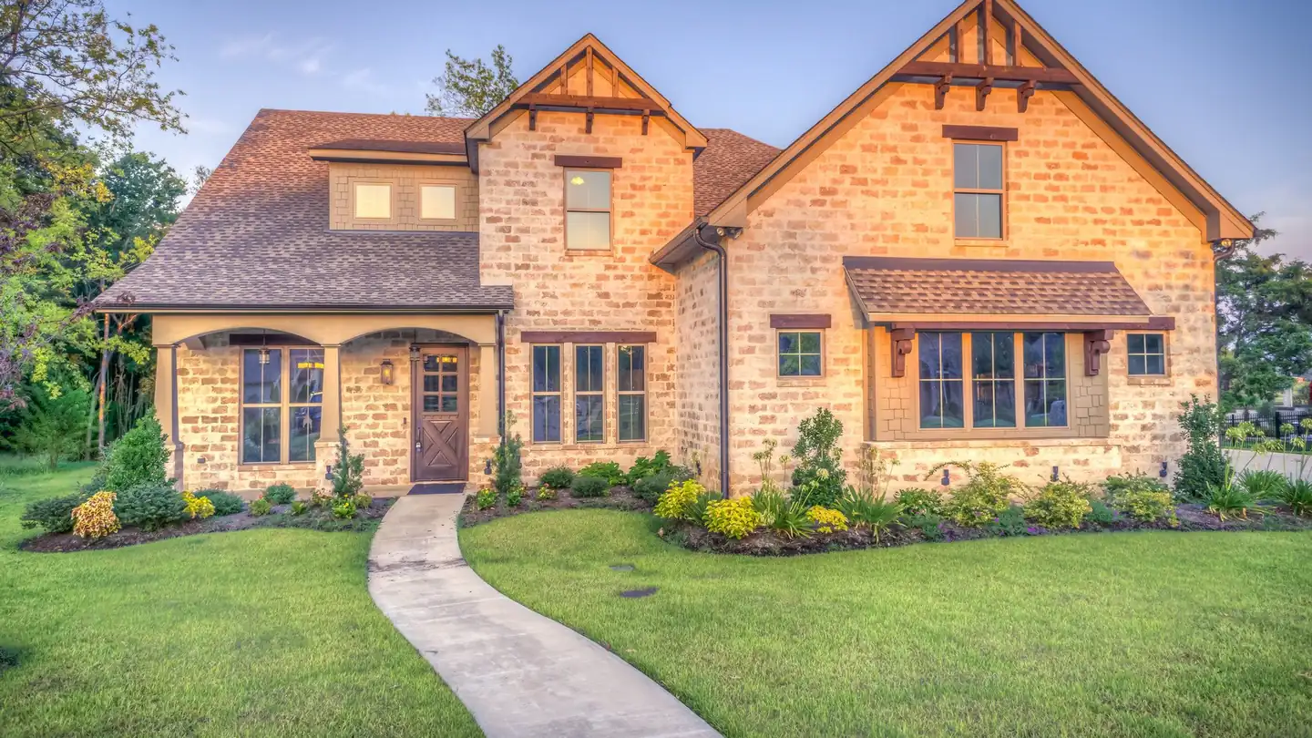 A new Caromark home with a brick and stone elevation and a landscaped walk
