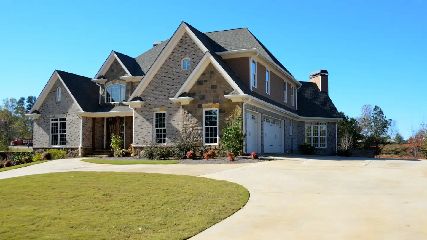 The approach to a Caromark-built home with a curved driveway