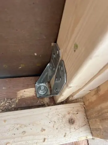 A steel connector strapping the new beam to the existing framing