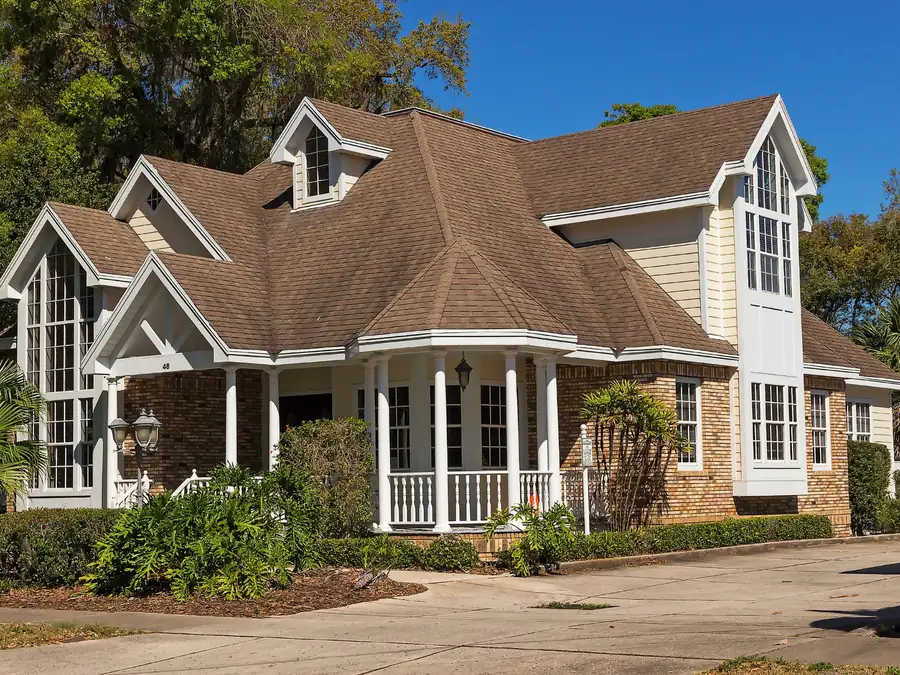A new Caromark home with a covered front porch, bay windows and gabled dormers