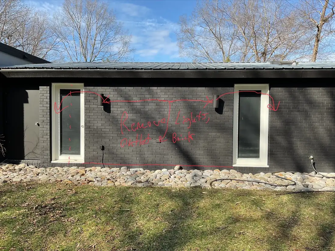 A painted brick rear elevation with the new opening marked out in red on the wall