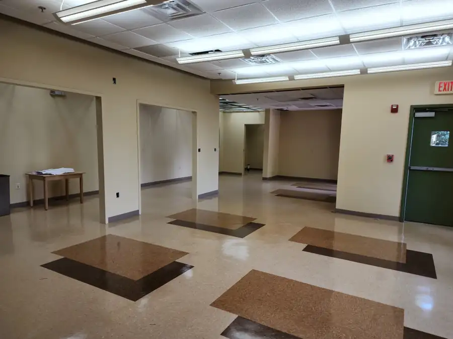 An open commercial floor plate during an upfit, flooring stripped back to the slab